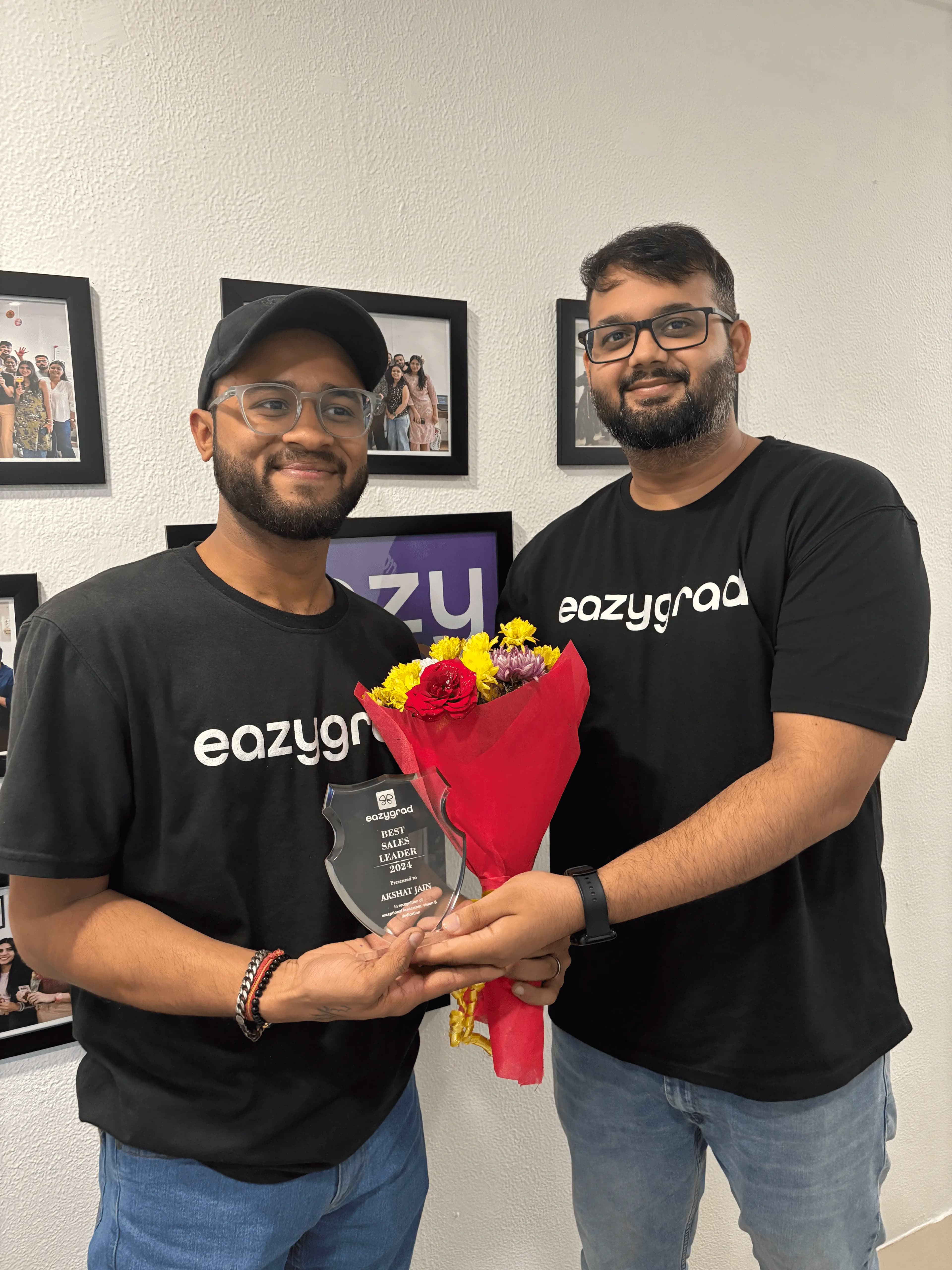 Two EazyGrad team members smiling in the office